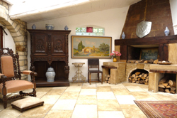 Stone entrance hall towards fireplace